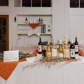 A wedding bar set up in a white room.