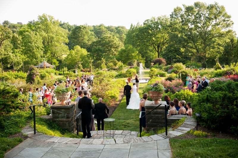A wedding ceremony in a rose garden.