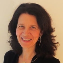 Headshot of a woman with shoulder-length dark hair and hoop earrings.